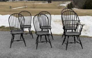 American Made Six Windsor Chairs set featuring 2 Sack Back Armchairs and 4 Bow Back Side Chairs in an antique black over red crackle finish.