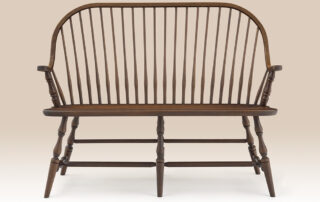 Cherry Continuous Arm Windsor Settee with a Windsor-style design, turned legs, and a Pennsylvania Russet finish. Made in Pennsylvania.