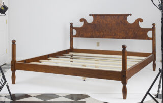 King Size Cannonball Bed with rolling pin headboard, turned posts, and a cannonball motif. Crafted in tiger maple wood. Made in the USA.