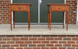 Shaker Stands with dovetailed drawers, simple turned legs, and a walnut drawer pull. Crafted in tiger maple wood. Made in the USA.