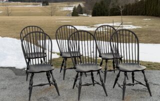 Six Side Windsor Chairs with antique black over red crackle finish, featuring traditional Windsor craftsmanship. Made in the USA.