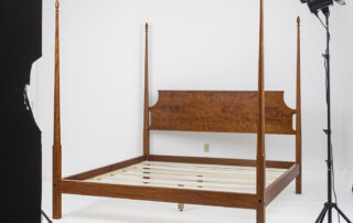 King Size Pencil Post Bed in tiger maple with pencil posts and a simple headboard and finials.