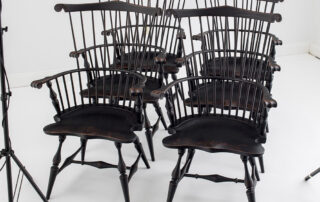 Six fan back Windsor armchairs in antique black over red crackle finish.