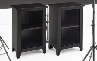 Pair of Cape Cod Bookcases in antique black over red with country styling.
