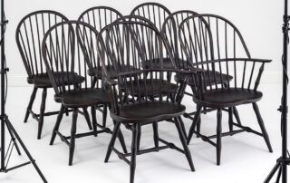 Set of 8 Windsor chairs with bamboo-style turnings and antique black over red finish.