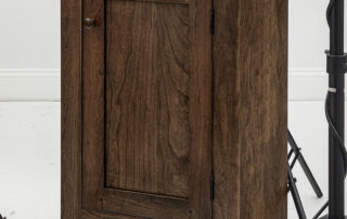Small cherry cabinet with flat panel and period walnut finish.