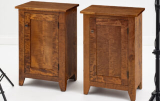 Pair of small tiger maple wood cabinets with walnut pulls and flat panel design.