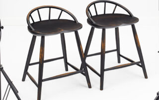 Two Abilene stools with modern farmhouse design and distressed antiqued black finish.