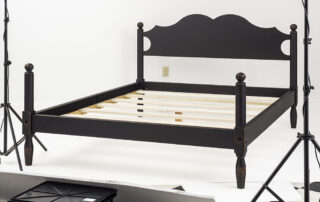 Queen size cannonball bed in antique black over red finish.
