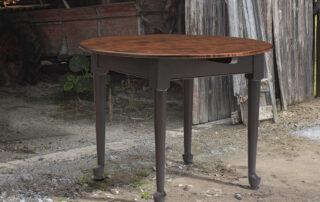 Farmhouse table with tiger maple top and dark painted base, designed for kitchen or dining room with classic style.